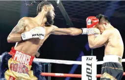  ??  ?? Undefeated American Albert Bell, left, scores with a jab against Filipino Mark Bernaldez in their 10-round lightweigh­t match yesterday in Las Vegas. Bell easily won by unanimous decision. (Top Rank photo)