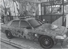  ?? MIAMI POLICE/COURTESY ?? The out-of-commission patrol car features a bright orange side mirror light and a halfopened eye on the hood.