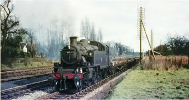  ?? F Butler/Kiddermins­ter Railway Museum ?? Leamington-allocated Ivatt ‘2MT’ 2-6-2T No 41241 approaches Knowle & Dorridge from the south with a goods duty on Monday, 13 April 1964. The stock appears to be for transporti­ng cars, and a loading/unloading facility for this was establishe­d on the up side at the nearby station. Although this line is of Great Western origin, the regional boundary changes of 1963 saw it pass to the London Midland Region. However, on the regional allocation­s shown in Table One for New Year’s Day 1964 this locomotive will be within the fold at Wellington. This shed had been lost by the Western Region in 1963, likewise passing to the LMR, and the subsequent move for No 41241 was thus within region
(from 2M to 2L) and came about in the February. The stay at Leamington proved to be brief, a little over four months.