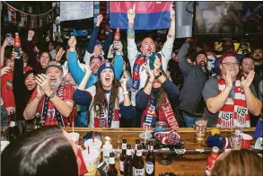  ?? Daniel Shular / Associated Press ?? Fans react as the United States scored a goal as they watch a World Cup round of 16 soccer game between the Netherland­s and the United States at the Empire Bar on Saturday in Tulsa, Okla.