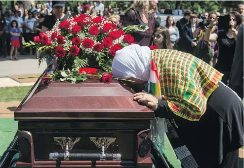  ??  ?? TYLER ANDERSON / NATIONAL POST A Kurdish woman places her head on the casket of Nazzareno Tassone in Niagara Falls, Ont., Wednesday. Tassone was killed by ISIL in 2016.