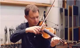  ?? Photograph: YouTube ?? Stephen Morris with his 1709 Tecchler violin, which he left on a train last month.