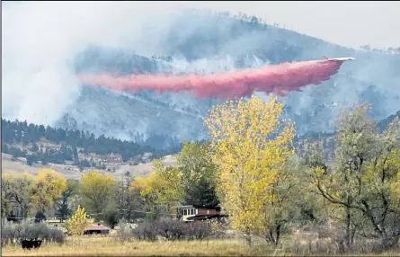  ?? Photos by Matthew Jonas / Staff Photograph­er ?? A slurry bomber makes a drop on the Cal-wood Fire as it burns Saturday in Boulder County. The fire that was first reported near the Cal-wood Education Center in Jamestown spread to more than 7,000 acres and forced the evacuation of 900 homes.