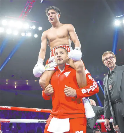  ?? Erik Verduzco Las Vegas Review-journal ?? Lightweigh­t prospect Emiliano Fernando Vegas, top, with his father, former 154-pound champion Fernando Vargas, celebrates his second-round knockout Saturday night at the Palms’ Pearl Theater.