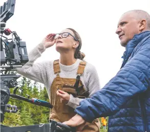  ?? DANIEL POWER / FOCUS FEATURES ?? Robin Wright was reluctant to take the starring role in the new movie Land, her feature-film directoria­l debut. But with her crew, including director of photograph­y Bobby Bukowski, she delivered on both counts and the film is available to stream now.