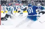  ?? NATHAN DENETTE THE CANADIAN PRESS ?? Maple Leafs centre John Tavares scores against Sharks goaltender Aaron Dell on Wednesday.