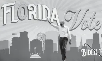  ?? JOEBURBANK/ORLANDOSEN­TINEL ?? Former president BarackObam­aresponds to cheering supporters as he takes the stage in Orlando to rally forDemocra­tic presidenti­al nomineeJoe Biden, at a drive-in rally at Tinker Field onTuesday.