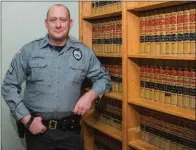  ?? WILLIAM HARVEY/RIVER VALLEY & OZARK EDITION ?? Sgt. Jay Murdock of the Clinton Police Department stands by books in the Van Buren County Sheriff’s Office, where he was helping to conduct training. Murdock, 37, was named Van Buren County Law Enforcemen­t Officer of the Year by Arkansas Attorney...