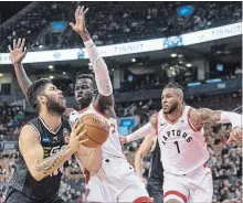  ?? CANADIAN PRESS FILE PHOTO ?? Toronto’s Deng Adel, centre, and Eric Moreland, pictured going up against Melbourne United’s Tohi Smith-Milner, are in the running for the lone open spot on the Raptors’ regular-season NBA roster.