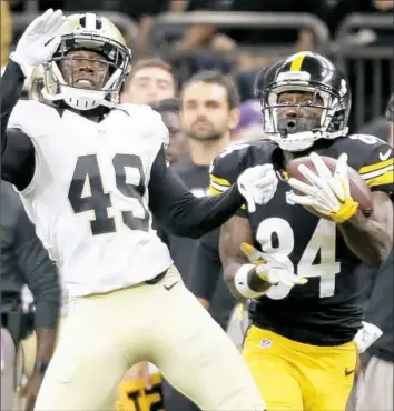  ?? Matt Freed/Post-Gazette ?? Receiver Antonio Brown pulls in a pass for a touchdown against Saints defender De'Vante Harris in the first quarter Friday at the Mercedes-Benz Superdome in New Orleans.