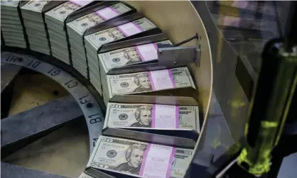  ??  ?? Packs of $20 notes are processed at the US Treasury. The US Federal Reserve, the European Central Bank and the Bank of England are all pumping money into their economies to try to ward off a depression. Photograph: Eva Hambach/AFP/Getty