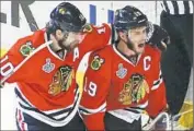  ?? Charles Rex Arbogast
Associated Press ?? PATRICK SHARP, left, of Chicago congratula­tes Jonathan Toews for his first goal of this Final.