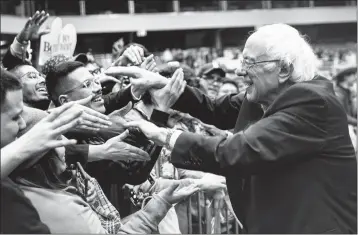  ?? JUAN FIGUEROA/THE DALLAS MORNING NEWS VIA AP ?? DEMOCRATIC PRESIDENTI­AL CANDIDATE U.S. Sen. Bernie Sanders, I-Vt., greets supporters during a rally at the Mesquite Arena on Friday in Mesquite, Texas.