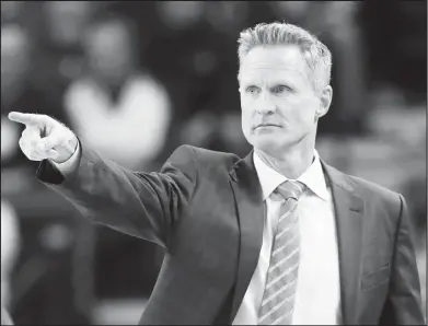  ?? Associated Press ?? Golden State Warriors head coach Steve Kerr directs his team during the first half of an NBA basketball game against the Atlanta Hawks in Oakland, Calif. Kerr is not yet ready to return to the bench as the franchise prepares for its third straight trip...