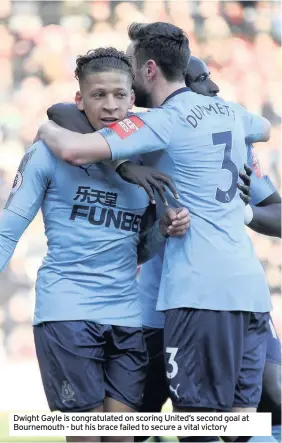  ??  ?? Dwight Gayle is congratula­ted on scoring United’s second goal at Bournemout­h - but his brace failed to secure a vital victory