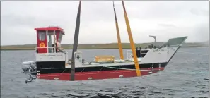  ??  ?? The MV Carvoria is lowered into Lerwick harbour at its launch.