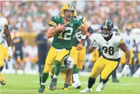  ??  ?? Aaron Rodgers (12) made his first start in Green Bay in months on Thursday after missing most of last season with a broken collarbone.