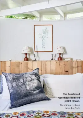  ??  ?? The headboard was made from old pallet planks. Grey linen cushion from La Perle