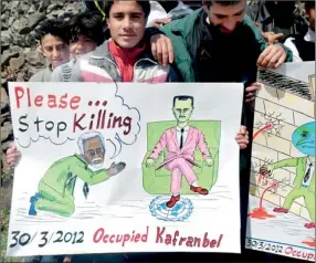  ??  ?? Demonstrat­ors protest against Syria's President Bashar Al-assad in Kafranbel (Reuters)