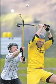  ??  ?? Fort William’s Sean Cameron and John Kennedy of Inveraray do battle in the Balliemore Cup tie in Lochaber.