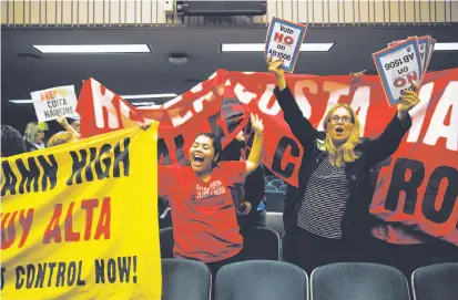  ?? Gabrielle Lurie / The Chronicle ?? Tenant rights supporter Leticia Arce (center) and an advocate for landlord rights rally in Sacramento over a measure to repeal the Costa-Hawkins Rental Housing Act, which limits the rent control rules cities and counties may adopt.