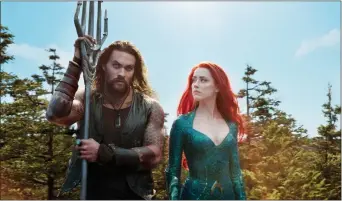  ?? ASSOCIATED PRESS ?? This image released by Warner Bros. Pictures shows Jason Momoa, left, and Amber Heard in a scene from “Aquaman.”