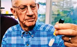  ?? ?? DEADLY: Edward Schantz in 1994 with a vial of undiluted botulinum toxin – enough for tens of thousands of lethal doses