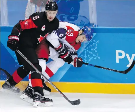  ?? JULIO CORTEZ/THE ASSOCIATED PRESS ?? Wojtek Wolski (8) of Canada checks Lukas Radil (69) of the Czech Republic during the first period of a preliminar­y-round men’s hockey game in Gangneung, South Korea, on Saturday. Canada was looking to improve to 2-0 in the tournament.