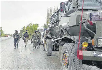  ?? ANI ?? Security personnel patrol the area near the site where the encounter broke out between security forces and terrorists, at Kapren, in Shopian on Friday.