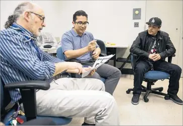  ?? Brian van der Brug Los Angeles Times ?? DR. MARC WEIGENSBER­G, left, leads a talk with diabetic patients Fabio Lara, 21, and Gabriel Leon, 26, at Los Angeles County-USC Medical Center. The group meetings often focus on diet, exercise and self-care.