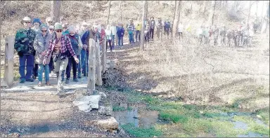  ?? Keith Bryant/The Weekly Vista ?? Hikers, led by Kripalu Mindful Outdoor guide Paula Hixson, stop briefly before crossing a small stream.