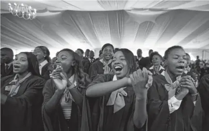  ?? Ben Curtis, Associated Press ?? A choir sings as Zimbabwe President Robert Mugabe presides over a student graduation ceremony at Zimbabwe Open University on the outskirts of Harare, Zimbabwe, on Friday. Mugabe made his first public appearance since the military put him under house...