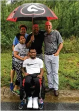  ?? CONTRIBUTE­D ?? Sister Teah, mother Tish, father Donny and Whit Marshall stand behind Devon Gales on the site where they hope to have a new handicapac­cessible home.