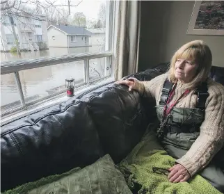  ?? WAYNE CUDDINGTON ?? Mary Courneyea at her house on rue Saint-Patrice in Gatineau, which is now unreachabl­e by car. She fears she will lose her house, which she had just put up for sale in hopes of retiring to a condo.