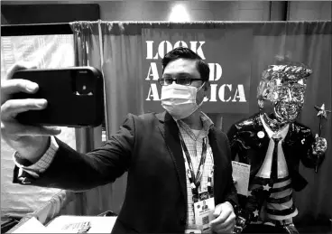  ?? JOHN RAOUX / ASSOCIATED PRESS ?? A conference attendee takes a selfie Friday in front of a gold statue of former president Donald Trump at the Conservati­ve Political Action Conference in Orlando, Fla.