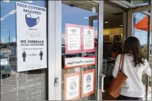  ?? AP ?? Although nearly a fifth of U.S. states don’t require people to wear masks to protect against COVID-19, some businesses are requiring employees and customers to be masked on their premises.