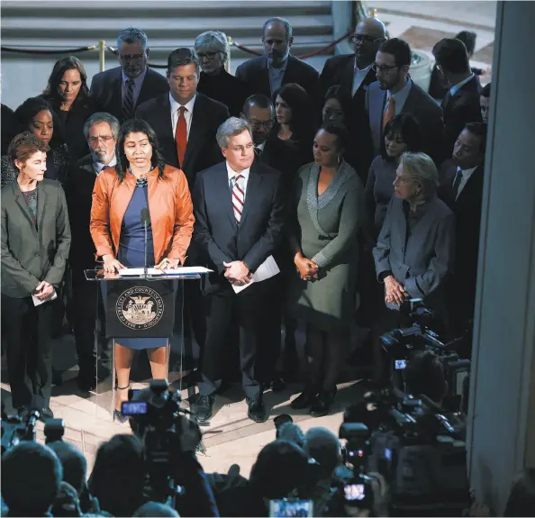  ?? Paul Chinn / The Chronicle ?? Above: Acting Mayor London Breed is surrounded by officials during a City Hall news conference after the announceme­nt that Mayor Ed Lee had died.