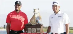  ??  ?? NASSAU: Hideki Matsuyama, right, of Japan, poses with Tiger Woods and the trophy after winning the Hero World Challenge golf tournament Sunday, in Nassau, Bahamas. — AP