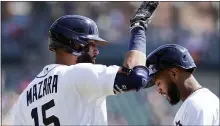  ?? CARLOS OSORIO — THE ASSOCIATED PRESS ?? Detroit Tigers’ Nomar Mazara taps Willi Castro’s helmet after hitting a two-run home run during Sunday’s home game against the Cleveland Indians. The Tigers fell, 9-3, and hosts Minnesota today.