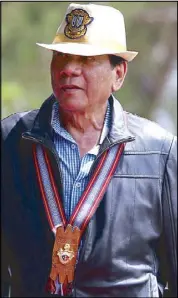  ?? KRIZJOHN ROSALES ?? President Duterte wears Class 1967 hat during the Philippine Military Academy alumni homecoming at Fort Del Pilar in Baguio City yesterday.