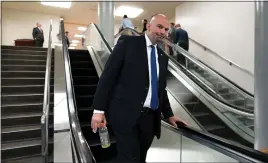  ?? J. SCOTT APPLEWHITE, FILE — THE ASSOCIATED PRESS ?? Sen. John Fetterman, D-Pa., takes an escalator at the Capitol in Washington last April.