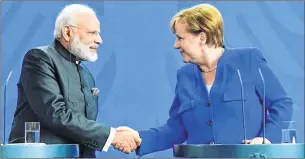  ??  ?? Indian Prime Minister Narendra Modi and German Chancellor Angela Merkel greet each other with handshake during a comprehens­ive review meet of bilateral relations. (File/AFP).