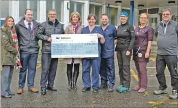  ??  ?? The team from Gallagher’s Fort William office hands over the money to staff at the Belford Hospital.