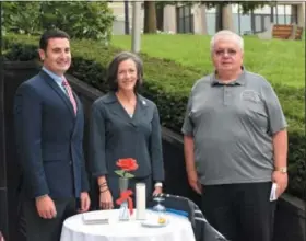  ?? MARIAN DENNIS — DIGITAL FIRST MEDIA ?? From left, Montgomery County Commission­er Joe Gale, Commission­ers’ Chairwoman Valerie Arkoosh and William Keyes stand behind a symbolic table set to remind viewers of those POW and MIA veterans.