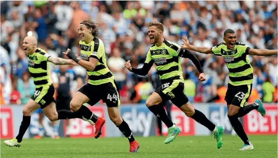  ?? PHOTO: REUTERS ?? Huddersfie­ld Town’s players celebrate after winning promotion to the Premier League.