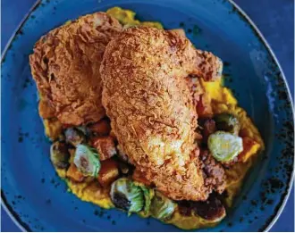  ?? Annie Mulligan ?? H-Town Hot Fried Chicken with garlic roasted butternut squash, Brussels sprouts and bacon marmalade is on the menu at State Fare.