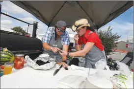  ?? NWA Democrat-Gazette/J.T. WAMPLER ?? Hannah Cicioni (left) and Nicole Craig, both of Rogers, get a taste of pork butt they cooked Saturday for the Frisco Inferno BBQ competitio­n in Rogers. It was the fifth year for the Frisco competitio­n, but the first serving as the Bikes, Blues & BBQ rally’s official barbecue competitio­n. Proceeds benefited Rotary Club of Downtown Rogers.