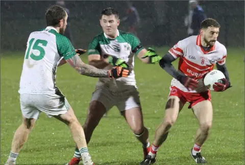  ??  ?? Niall Breen of Kilanerin skips away from St. James’ duo Liam Murphy and Tomás Walsh.