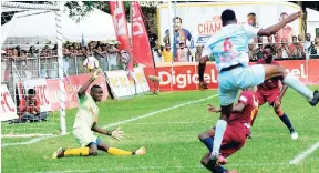  ?? PHOTOS BY SHORN HECTOR/PHOTOGRAPH­ER ?? St Andrew Technical’s goalkeeper Jaedin White (left) leaves his line to block a shot from Emelio Rousseau (right) of St George’s College during their ISSA/Digicel Manning Cup encounter at Winchester Park yesterday.