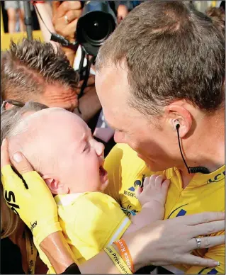  ??  ?? That’s my boy: Baby Kellan cries as he is reunited with his father Chris Froome